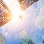 Airplane in the sky with skyscrapers